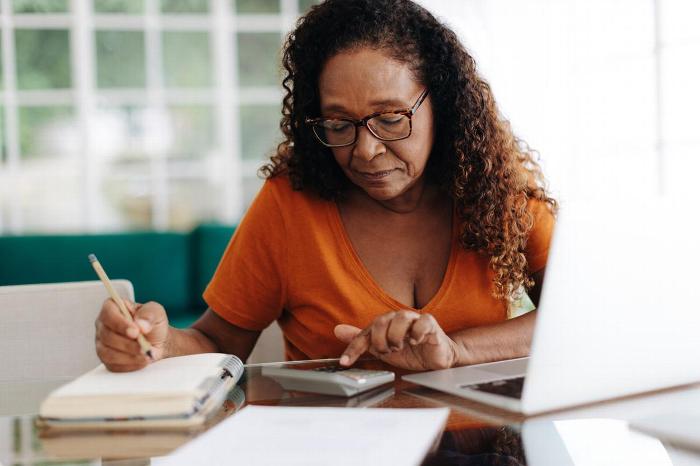 A woman sitting at a table planning her retirement