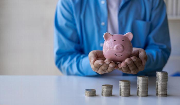 A man holding a piggy bank