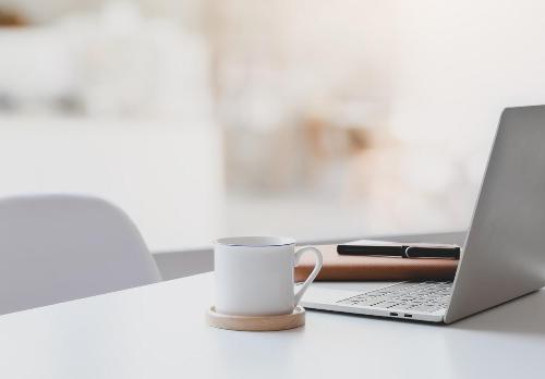 A laptop and a cup of coffee on a desk